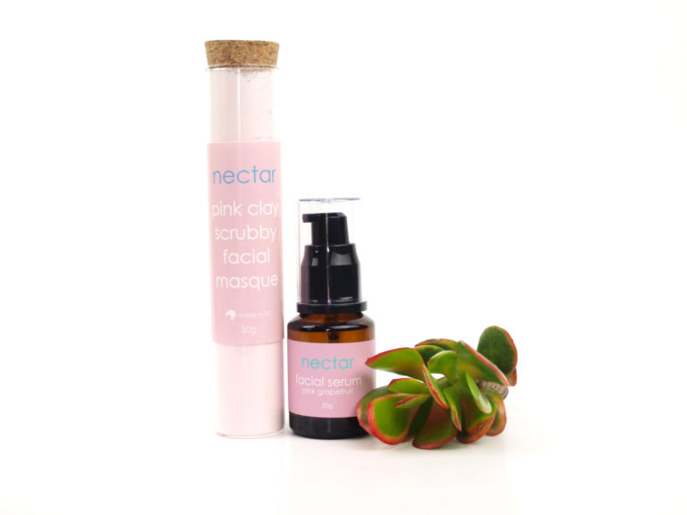 tube of pink clay and bottle of serum with plant